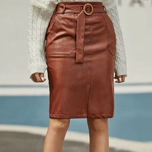 Slit him belted faux leather skirt